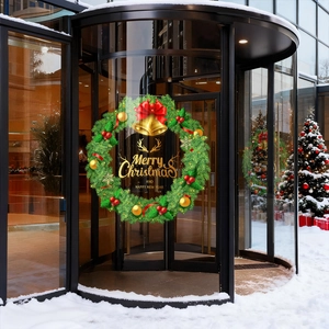 Sticker couronne de Noël avec nœud rouge et cloches dorées sur une porte vitrée