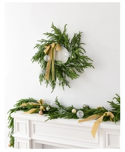 Detail of Norfolk pine garland and wreath set with elegant champagne velvet bows