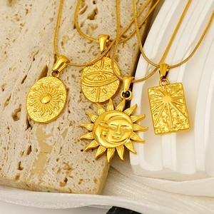 Retro gold stainless steel tarot sun pendant necklaces on white aesthetic display