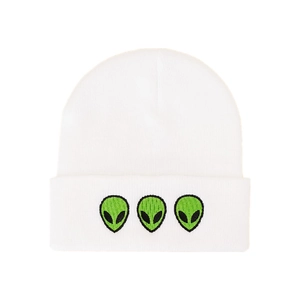 Detail of three green alien embroidery patterns on a white knit beanie cuff