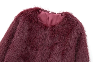 Close-up of fluffy burgundy faux fur texture on elegant round neck short coat