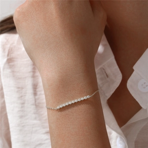 Close-up of minimalist S925 sterling silver bar bracelet with sparkling diamonds