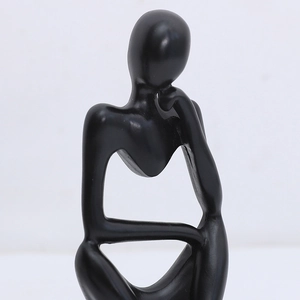 Close-up of minimalist black matte thinker sculpture with modern abstract art details