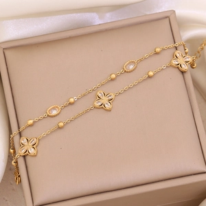 Detail of a double-layer gold flower bracelet with pearls and crystals on a luxury display