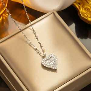 Silver heart zircon pendant necklace on luxury gold jewelry box for elegant gift display
