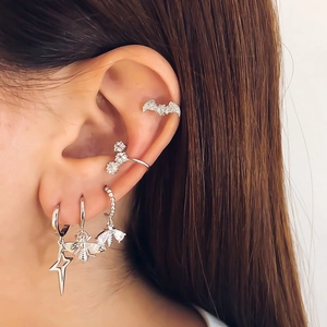 Silver bat and flower ear cuff set with bee and star pendants worn on the ear