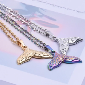 Minimalist stainless steel whale tail necklaces in gold, silver, and rainbow finishes