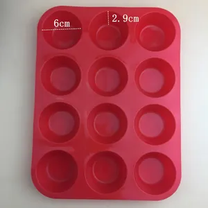 Macro detail of red 12-cup silicone muffin mold with dimensions 29x21.8x3cm