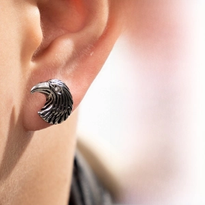 Detailed macro view of a vintage eagle head stud earring with intricate feather textures