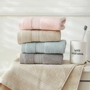 Close-up of soft cotton towel texture in pastel pink, beige and blue colors