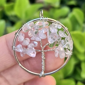 Macro shot of a handmade life tree pendant with silver wire and clear crystal leaves