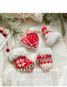 Detail of red knit strawberry and Christmas boot ornaments with soft faux fur trim
