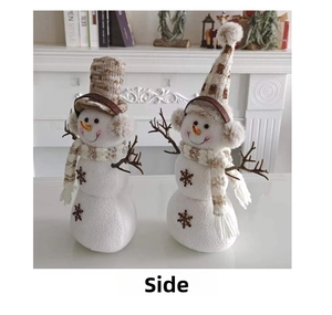 Macro detail of two snowman plush figures with knit hats and checkered scarves for Christmas