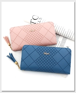 Detail of pink and blue long wallets with quilted rhombus pattern and tassel zipper