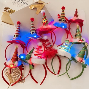 Detail of glowing LED Christmas headbands with sequins and plush holiday themed decorations