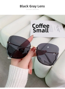 Detail of rimless butterfly sunglasses with black-grey gradient lenses and gold metal hinge