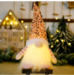Close-up of pink sequin Christmas gnome with LED lights and long white plush beard