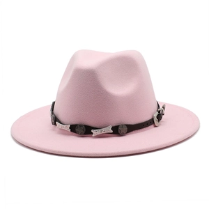 Detailed close-up of pink wool fedora with a studded leather belt and vintage star buckle