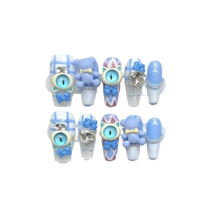 Handmade light blue press-on nails with purple bear, cat eye gems, and 3D bow accents
