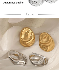 Detailed view of irregular pleated 316 stainless steel earrings with molten gold texture