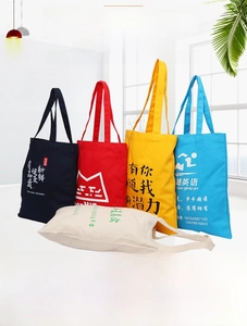 Close-up of colorful customized canvas tote bags with printed slogans and designs