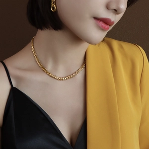 Elegant 18k gold-plated titanium leaf necklace set shown on a professional fashion model