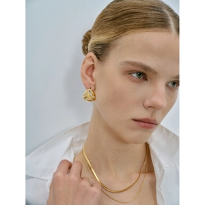 Macro detail of 18k gold plated drop earrings and double layer necklace set for women