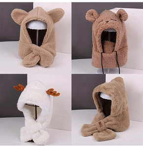 Detail view of four plush winter hats with ears in khaki, brown, and white soft fleece