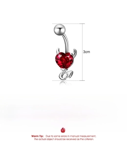 Detail view of silver devil heart belly ring with red zircon and copper material specs