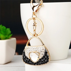 Macro detail of gold handbag keychain with sparkling heart crystal and rhinestones