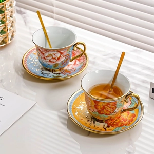 European luxury ceramic floral tea cup set with gold trim and spoons on marble table