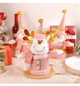 Pink Christmas candy jars with plush reindeer and snowman decor in festive setting