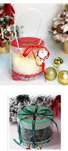 Detail of round transparent Christmas gift boxes with festive ribbons and LED light decor