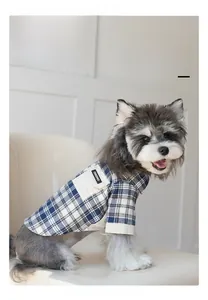 Detail of blue plaid pet shirt featuring a white pocket with woven label on dog
