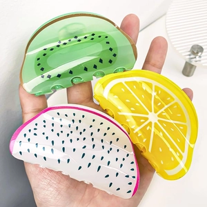 Detail of acrylic fruit hair clips in kiwi, lemon and dragon fruit shapes