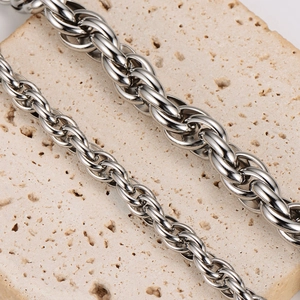 Minimalist silver twist chain necklace in two thicknesses on a stone background