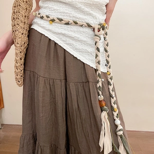 Detail of bohemian braided waist chain with colorful resin beads and fringe tassels