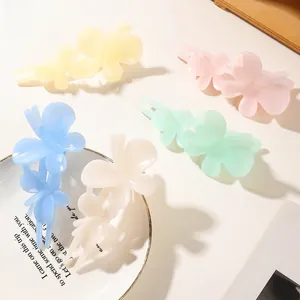 Detailed view of butterfly-shaped matte hair clips in five assorted macaron colors