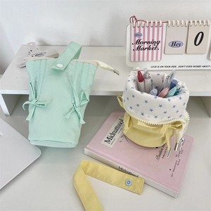 Detail of macaron pencil case with bow drawstring and star pattern lining in soft canvas