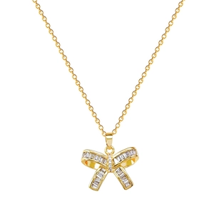 Luxurious gold butterfly necklace with shimmering zircon crystals on a white background