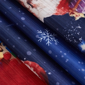 Close-up of Christmas curtains featuring navy snowflake mesh and Santa Claus print fabric