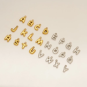 Macro view of 3D bubble letter pendants in gold and silver for DIY jewelry making