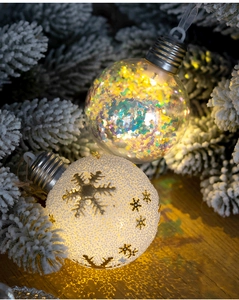 Detail of Christmas bulb ornaments with golden snowflakes and colorful sequins