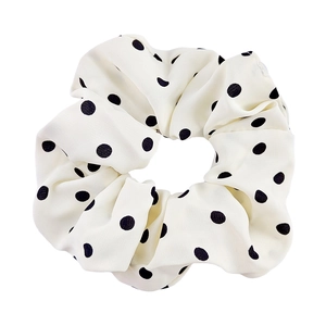 Elastic white scrunchie with black polka dot pattern for elegant ponytail styling