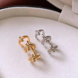 Detail shot of 18k gold plated T-shape earrings with zircon studs in a white jewelry box