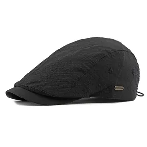 Classic black breathable ivy cap with a textured finish and vintage metal side logo