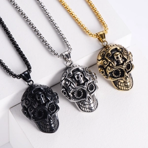 Detail of skull necklaces in black, gold, and silver with baroque patterns