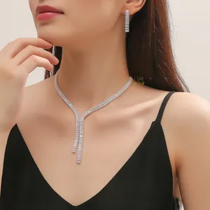 Detailed view of elegant silver bridal necklace and earrings set with rectangle zircons