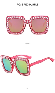 Macro detail of rose red square sunglasses with white rhinestones and rainbow lenses