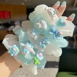 Detail of blue and white organza scrunchies with Cinnamoroll charms and floral accents